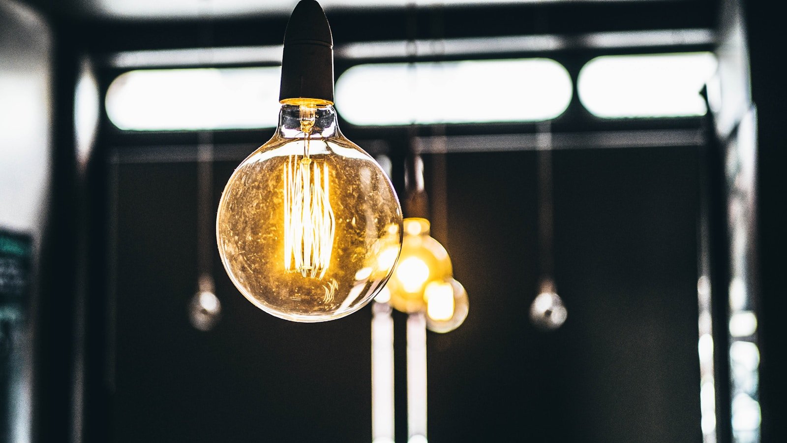Hanging filament light bulbs lit inside a room